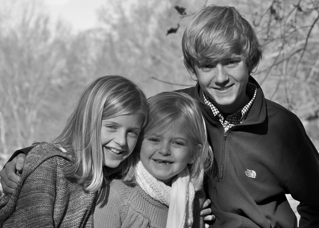 Capturing the closeness of three siblings during a Christmas card photo shoot at Wellesley College by Echo Cove Photography