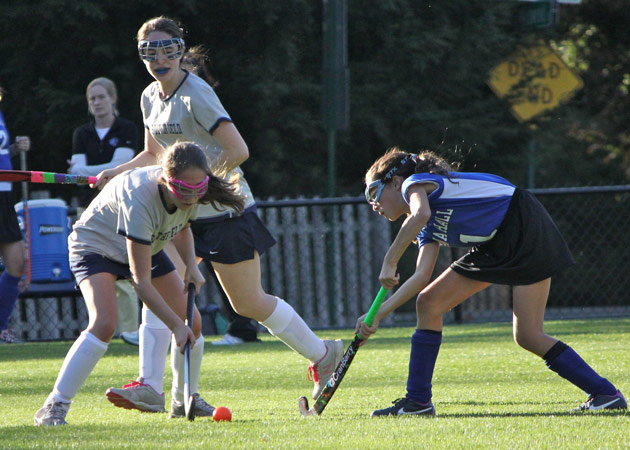 Capturing the fun of a face-off in a fall field hockey game at the Dana Hall School in Wellesley MA by Echo Cove Photography