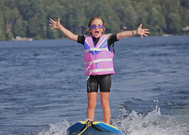 Capturing the fun of a 5-year-old girl water skiing on Lake Sunapee in the summer by Echo Cove Photography